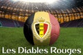 The Red Devils on Belgium language on football team ball on big stadium background. Belgium Team competition concept. Belgium flag Royalty Free Stock Photo