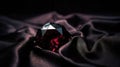 a red diamond sitting on top of a black cloth covered in satin Royalty Free Stock Photo