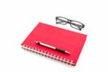 Red Diary Book with old glasses and pen. Royalty Free Stock Photo