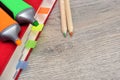 Red diary notebook and colored pencils, marker on the table wood