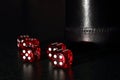 Red Dice with a Black Dice Cup Royalty Free Stock Photo