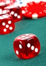 Red dice on a casino table with chips Royalty Free Stock Photo