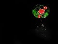 Red dice in a cocktail glass on black background. casino series Royalty Free Stock Photo