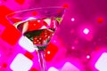 Red dice in the cocktail glass on blur pink background