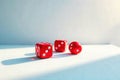 Red dice cubes resting on a bright surface illuminated by sunlight casting shadows, presenting a simple game of chance concept. Royalty Free Stock Photo