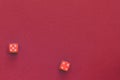 Red dice on a dark red background. Gambling concept, top view Royalty Free Stock Photo