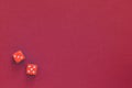 Red dice on a dark red background. Gambling concept, top view Royalty Free Stock Photo