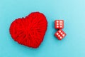 Red dice and heart on the blue background