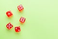 Red dice lying on a green background. Place for text Royalty Free Stock Photo
