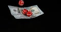 Red Dice rolling on Dollar Bills against Black Background Royalty Free Stock Photo