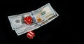 Red Dice rolling on Dollar Bills against Black Background Royalty Free Stock Photo