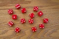 Red Dice scattered on an Oak Table Royalty Free Stock Photo