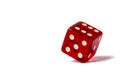Red dice standing in equilibrium on the edge and showing 6 isolated on a white background, red hexagonal cube