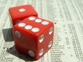 Red dice on stock report Royalty Free Stock Photo