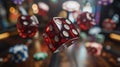 Red dice with white dots falling in mid-air, other dice and chips out of focus in the background Royalty Free Stock Photo