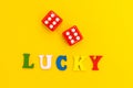 Red dice on a yellow background, the inscription `lucky