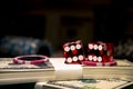 Red dices on chip and dollar bills, casino concept Royalty Free Stock Photo