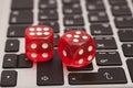 Red dices stacking on a laptop