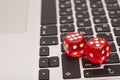 Red dices stacking on a laptop