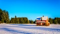 Red dilapidated and abandoned house in a wide snow covered field in Glen Valley in the Fraser Valley of British Columbia Royalty Free Stock Photo