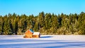 Red dilapidated and abandoned house in a wide snow covered field in Glen Valley in the Fraser Valley of British Columbia Royalty Free Stock Photo