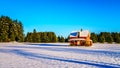 Red dilapidated and abandoned house in a wide snow covered field in Glen Valley in the Fraser Valley of British Columbia Royalty Free Stock Photo