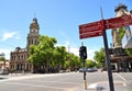 Red Directions arrow sign pointing to famous places with the clock tower at Bendigo\'s town hall on main street in CBD. Royalty Free Stock Photo