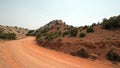 Red dirt and gravel Crooked Creek Road through the Pryor Mountains in Wyoming