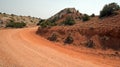 Red dirt and gravel Crooked Creek Road through the Pryor Mountains in Wyoming