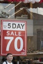 Red discount poster in shoe store window. It writes 70 percent discount Royalty Free Stock Photo