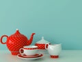 Red dishware on a blue background Royalty Free Stock Photo