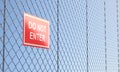 Red Do Not Enter Sign on Metallic Wire Mesh Fence