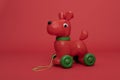 Red dog pull toy on a red background Royalty Free Stock Photo