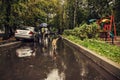 A red dog runs on a wet road in the rain Royalty Free Stock Photo