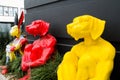 Red dog, Yellow dog and mixed color rabbit on human body sculptures sitting, is an artwork display by Gillie and Marc gallery.