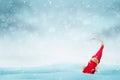 Red doll on the snow. Christmas concept image with free space for greeting text Royalty Free Stock Photo