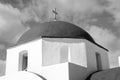 Red dome with cross detail in Mykonos, Greece. Church building architecture on sunny outdoor. Chapel on blue sky Royalty Free Stock Photo