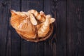 Red cat washes, sitting in a basket on a wooden background, studio Royalty Free Stock Photo