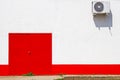 Red door and an airconditioner on the wall Royalty Free Stock Photo