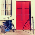 Red door and blue bicycle in old european house, Amsterdam. Royalty Free Stock Photo