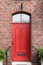 A red door on a brick building in a German village