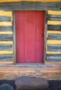 Red door in colonial American log cabin
