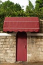 Red door cover with brick and leaf cover Royalty Free Stock Photo