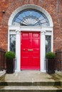 A red door in Dublin, Ireland. Arched Georgian door house front Royalty Free Stock Photo