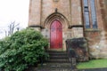 Elegant Red Church Door with Gothic Iron Details Royalty Free Stock Photo