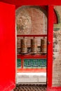 A red door with prayer wheels at the Kumbum Monastery, a Tibetan cultural monument in Xining, China Royalty Free Stock Photo