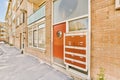 the door of a brick building with an orange door Royalty Free Stock Photo