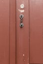 Red painted wooden door with straight metal knob Royalty Free Stock Photo