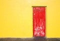 Red door on yellow wall Royalty Free Stock Photo