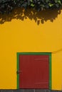 Red door on yellow wall Royalty Free Stock Photo